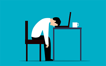 A man's head drops onto his keyboard showing his frustration with onlne applications