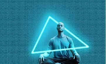 A man meditating with a neon triangle light going around him